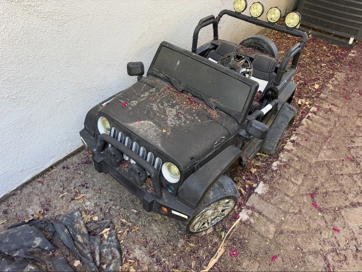 Old ride-on toy and bulky backyard items ready for hauling