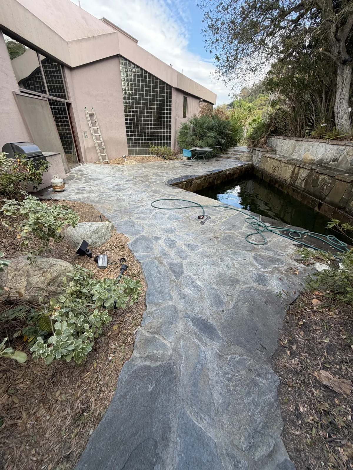 House and patio area after hillside clearing